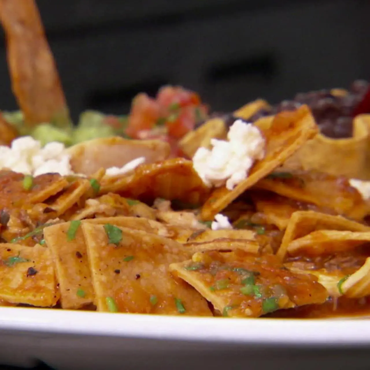 Chilaquiles Rojos (Traditional Mexican Breakfast Dish)