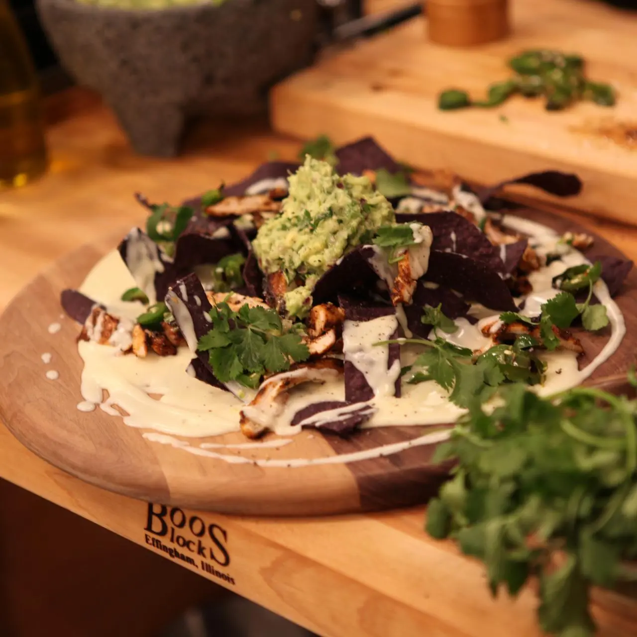 Grilled Chipotle Honey-Glazed Chicken Nachos with Monterey Jack Cheese Sauce, Avocado Relish and Charred Jalapenos
