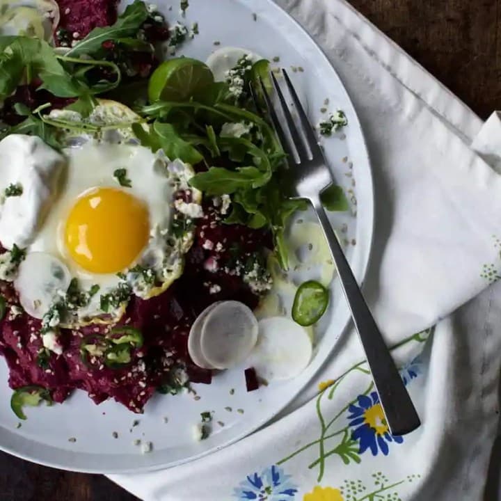 Beet Chilaquiles with Fried Eggs & Crumbly Herb Cheese