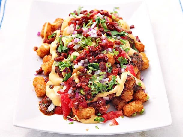 Totchos (Tater Tot Nachos) With Cheese Sauce, Charred-Tomato Salsa, Chorizo, and Pickled Jalapeños Recipe